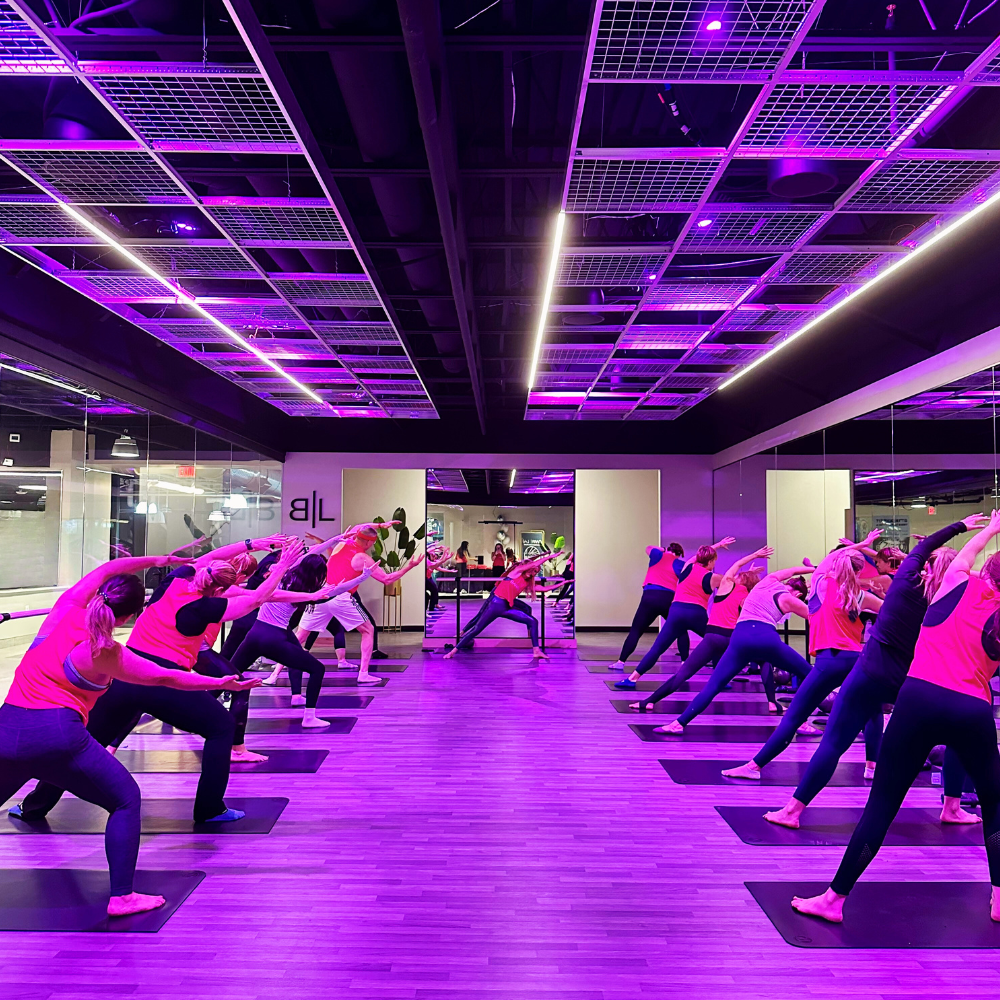 15 people taking a barre class at newtown athletic club